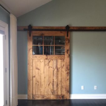 pine-stained-barn-door-with-glass-installed